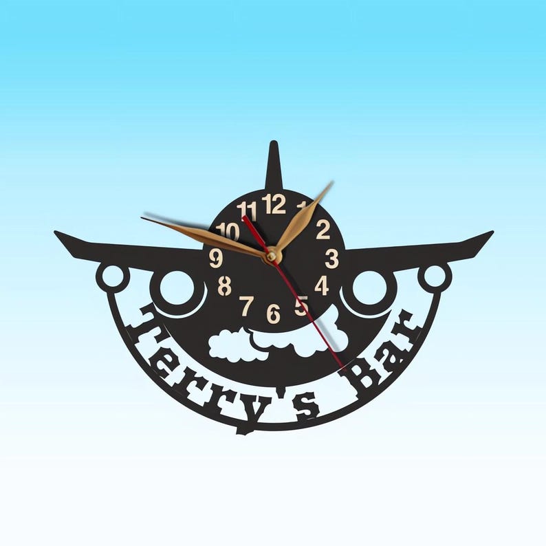 May include: Black airplane-shaped wall clock with gold hands and numbers. The clock has a white cloud design and the text "Terry's Bar" around the edge.