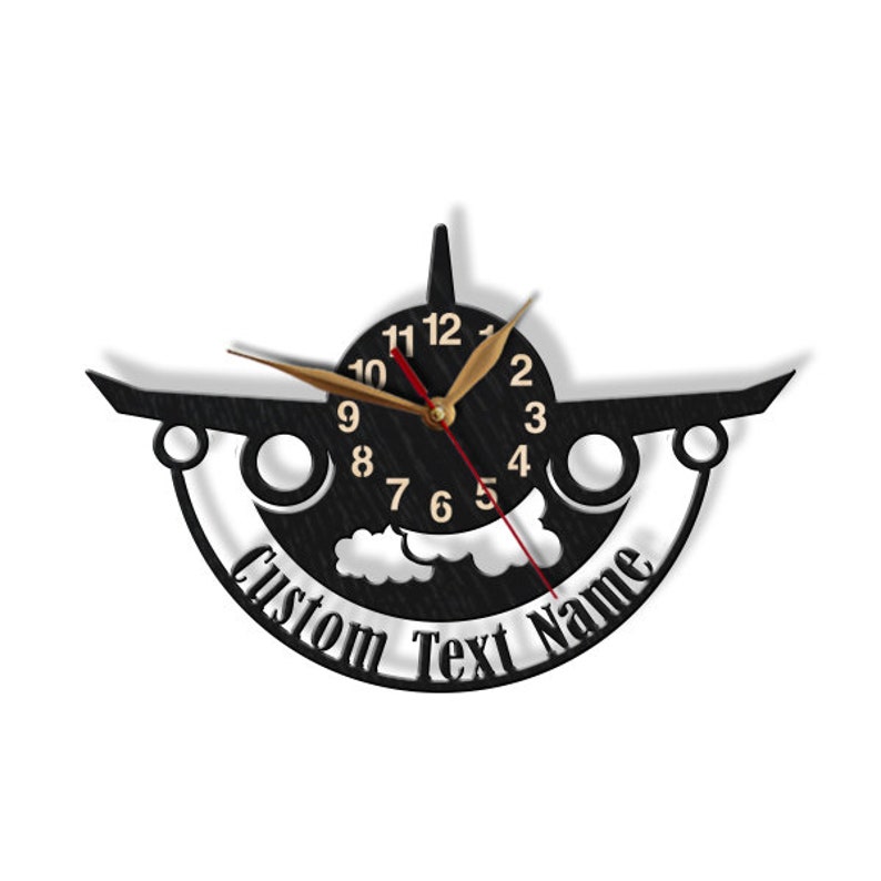 May include: Black airplane-shaped wall clock with gold hands and a white cloud design. The clock face has gold numbers and the text "Custom Text Name" is printed below the clock face.