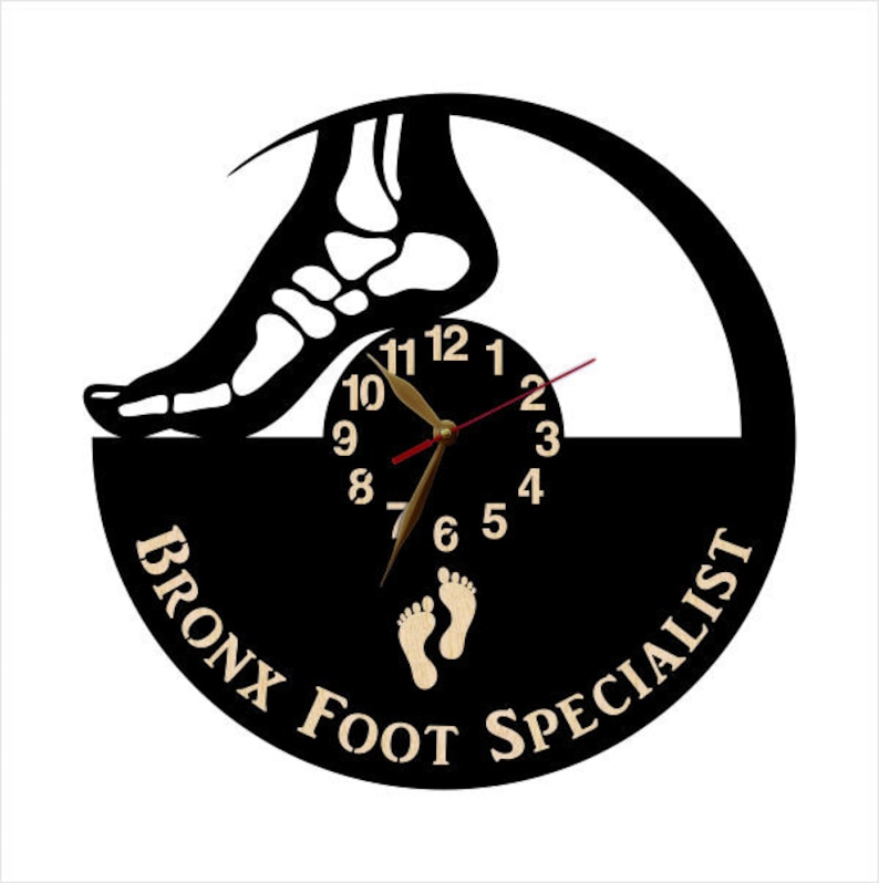 May include: A black and white wall clock with a foot skeleton design. The clock face is black with gold hands and numbers. The text "BRONX FOOT SPECIALIST" is printed on the bottom of the clock.