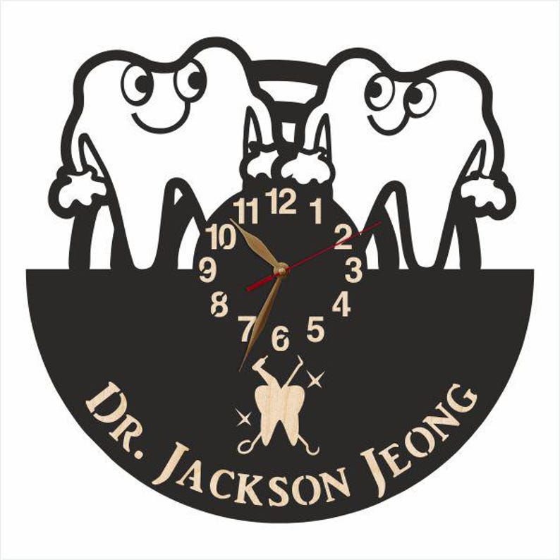 May include: Black and white clock with a dentist theme. The clock features two cartoon teeth with smiling faces and a clock face with the numbers 1 through 12. The clock is surrounded by a black background with the text "Dr. Jackson Jeong" in white.