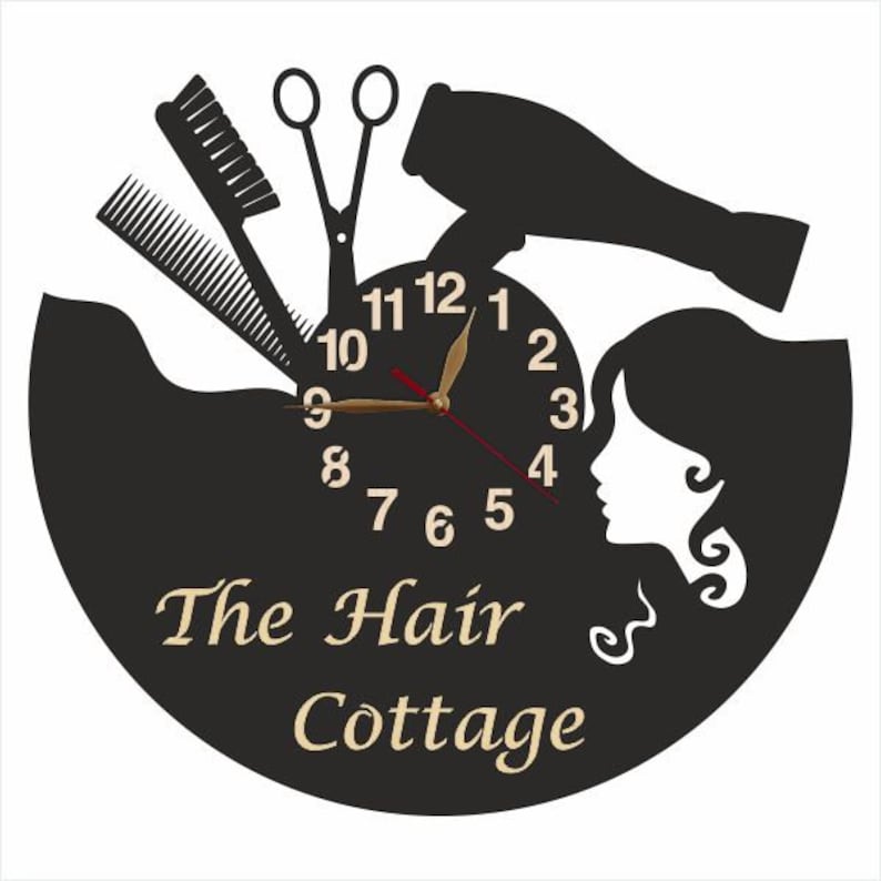 May include: Black and white clock with a hair salon theme. The clock face features a hair dryer, scissors, combs, and a woman's silhouette. The clock face reads "The Hair Cottage".