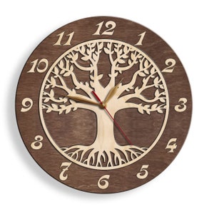 May include: A brown wooden wall clock featuring a tree of life design. The clock has a light brown wood background with the tree cut out of the wood. The clock face has Roman numerals for the hours and the hands are black and red.