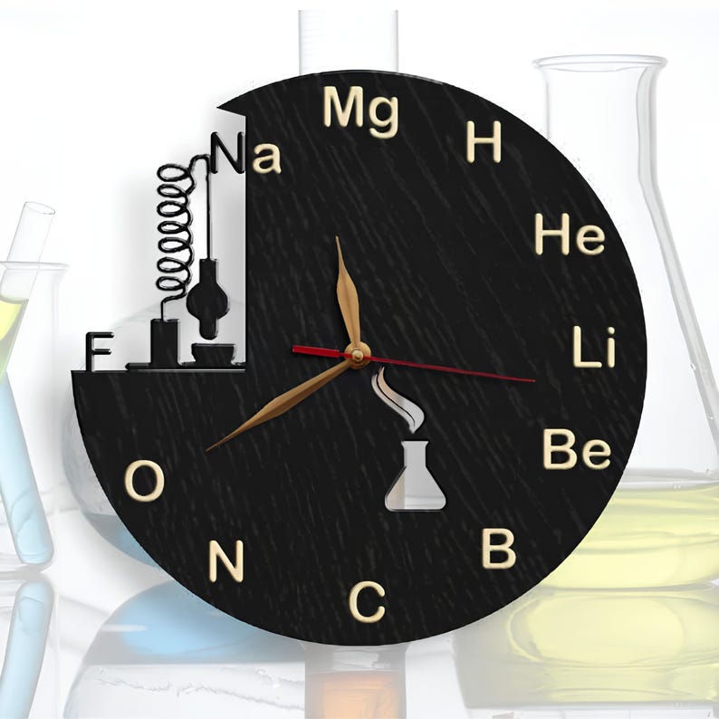 May include: A black wooden clock with gold lettering and a chemical element symbol design. The clock features a black and gold hand and a red second hand. The clock face has a black background with gold lettering for the numbers and the chemical element symbols. The clock is shaped like a circle and has a black wooden frame.