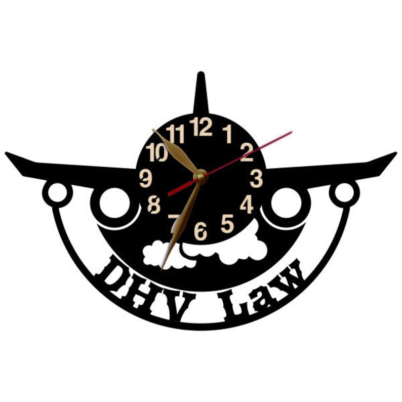 May include: Black airplane wall clock with gold hands and white clouds. The clock face has the numbers 1 through 12 and the words "DHV Law" are printed below the clock face.