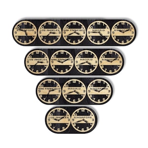 May include: A multi-time zone wall clock with a black wooden base and multiple circular clock faces. Each clock face displays the time for different cities: Singapore, Los Angeles, San Francisco, and Madrid. The clocks are arranged in a tiered design.