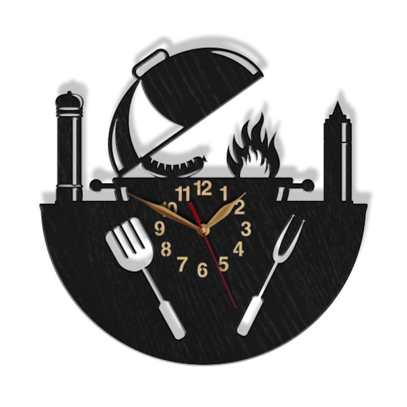May include: Black and white wall clock with a grill, spatula, and fork design. The clock face has a black background with white numbers and hands.