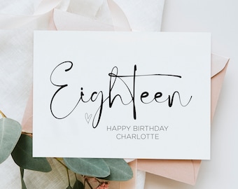 Puede incluir: Una tarjeta blanca con caligrafía negra que dice "Eighteen" con un pequeño símbolo de corazón. Debajo del texto está "Happy Birthday Charlotte".