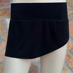 May include: A black skirt with a wide waistband and a slightly asymmetrical hemline.
