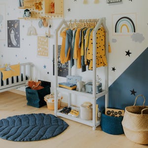 Boho nursery setup featuring an open clothing rail that makes outfit selection easy