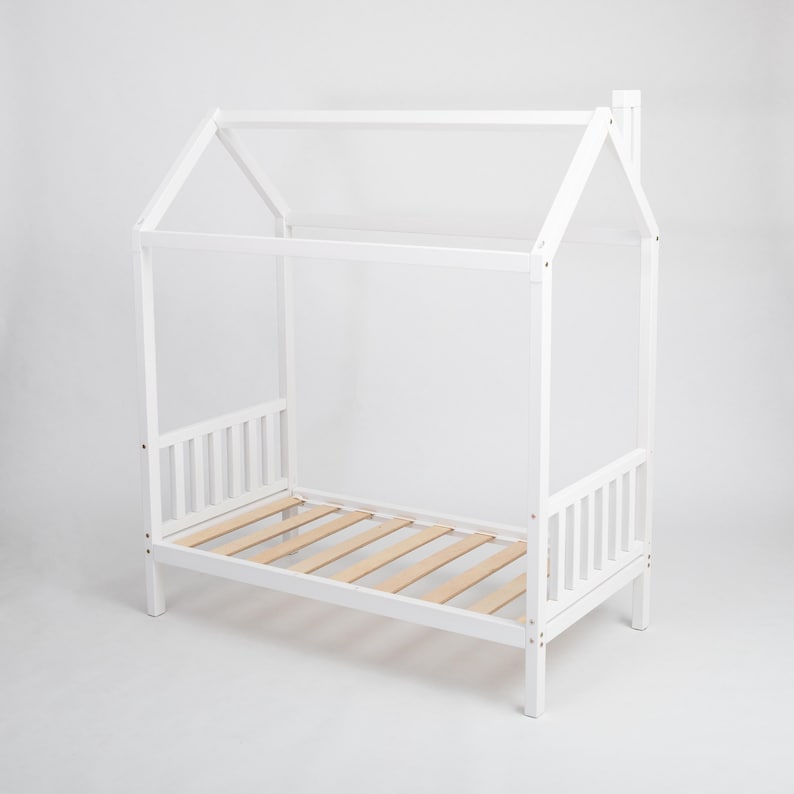 White solid wood platform house bed frame with birch plywood slats designed for unisex toddler rooms.