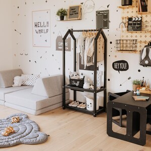 Child-friendly black clothing rail designed to prevent bedroom closet clutter