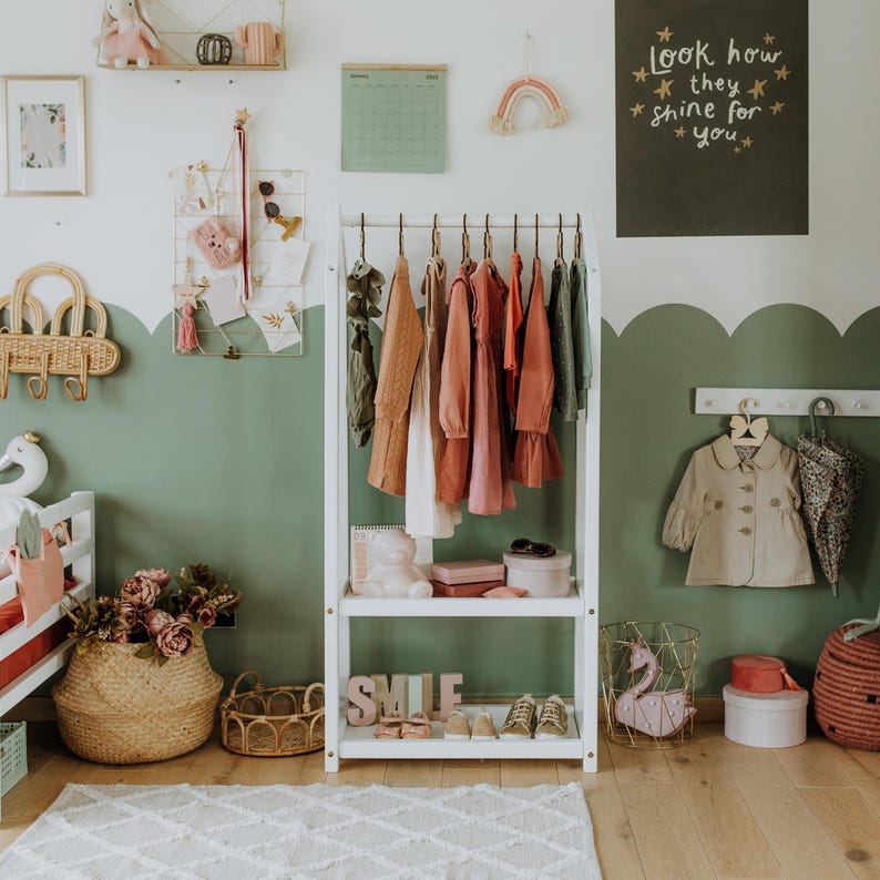 Self-serve child wardrobe station fitted with wooden coat hangers