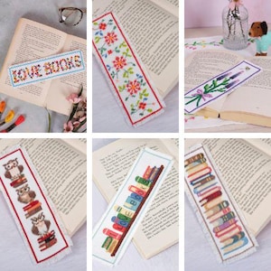 May include: A set of 10 colourful cross-stitch bookmarks featuring various designs, including flowers, owls, books, and a sprig of lavender. The bookmarks are all white with a fringed edge.