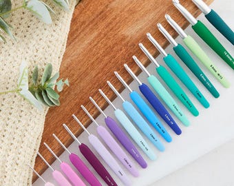 May include: A set of 18 colourful crochet hooks, ranging in size from 2.00 mm to 10.00 mm. The hooks are arranged in order of size, with the smallest hooks on the left and the largest hooks on the right. The hooks are made of metal and have a smooth, comfortable grip.
