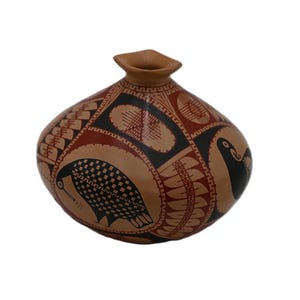 May include: A brown ceramic vase with a geometric pattern and black bird designs. The vase has a rounded body and a narrow neck.