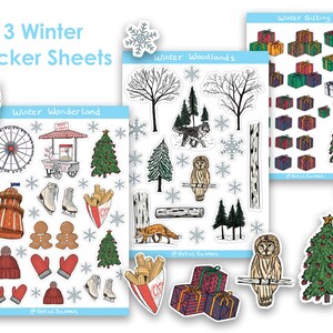 May include: Three sticker sheets featuring winter-themed illustrations. The first sheet is titled "Winter Wonderland" and includes images of a Ferris wheel, a hot dog stand, a Christmas tree, ice skates, and gingerbread people. The second sheet is titled "Winter Woodlands" and includes images of trees, a wolf, an owl, a fox, and a birch tree. The third sheet is titled "Winter Gifting" and includes images of wrapped presents and a Christmas tree.
