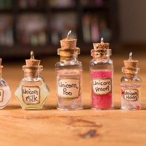 May include: Seven small glass bottles with cork stoppers and labels that say "Unicorn Drool", "Unicorn Milk", "Unicorn Poo", "Unicorn Venom", "Unicorn Horn", and "Unicorn Pee".