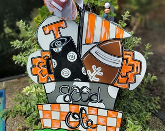 May include: A wooden sign with a football, a football helmet, and a Tennessee Volunteers logo. The sign says "Good Ole Rocky Top" with football yard lines at the bottom.