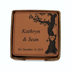 May include: A set of brown leather coasters with a tree design and the text "Kathryn & Sean Est. December 14, 2016" engraved on them.