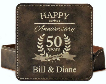 May include: A brown leather coaster with the text "Happy Anniversary 50 years" and "Bill & Diane" in gold lettering.