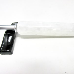 May include: A white pen with a black and silver cap. The pen is made of a translucent material with a marbled effect.
