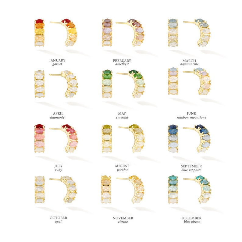 May include: Twelve pairs of gold hoop earrings with a semi-circle of gemstones. Each pair represents a different month of the year and features a different birthstone. The earrings are arranged in rows of three, with the months listed below each row.