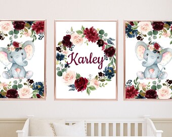 May include: Three watercolor prints featuring a floral wreath with a gray elephant in the center. The middle print has the name "Karley" in the center of the wreath.