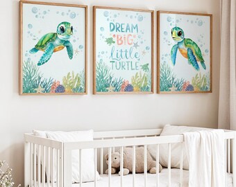 May include: Three framed watercolor prints with a baby turtle theme. The prints feature a green and blue turtle, bubbles, and aquatic plants. One print reads "Dream Big Little Turtle" in blue and green.