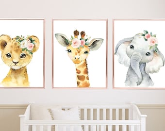 May include: Three watercolor animal prints with floral crowns. A lion cub, a giraffe, and an elephant are featured in the prints. The prints are set against a white background and have a gold frame.