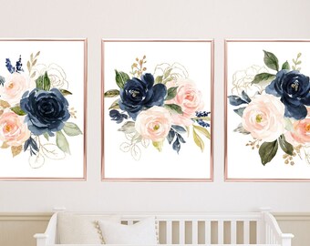 May include: Three watercolor prints featuring navy blue and blush pink floral bouquets with gold accents. The prints are framed in a rose gold frame.