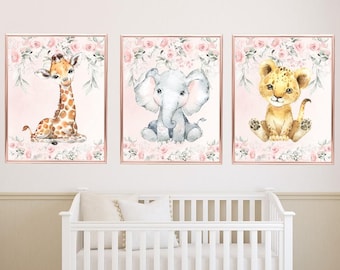 May include: Three watercolor prints featuring a giraffe, elephant, and lion cub. Each animal is surrounded by pink flowers and greenery on a light pink background.