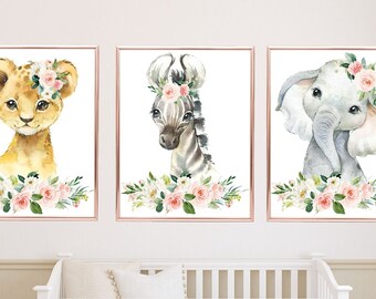 May include: Three watercolor prints featuring a lion, zebra, and elephant with floral crowns. Each animal is surrounded by pink and white flowers and greenery.