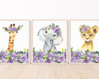 May include: Three watercolor paintings of animals wearing flower crowns. The animals are a giraffe, an elephant, and a lion. The flowers are purple and green.
