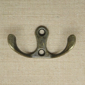 Old retro style hook - a vintage effect bronze-colored double hook for keys, towels, tea towels