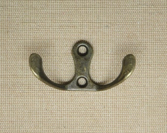 Old retro style hook - a vintage effect bronze-colored double hook for keys, towels, tea towels