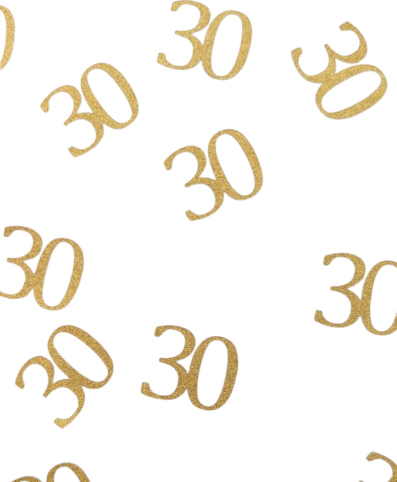 May include: Gold glitter confetti with the number 30 scattered on a white background.