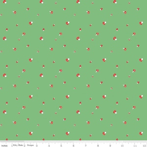 May include: A green fabric with a repeating pattern of red and white mushrooms.