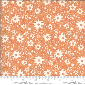 May include: A peach-coloured fabric with a white floral pattern. The fabric is covered in small white flowers with a simple design. The fabric has a subtle texture and a soft feel.