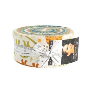 May include: A rolled bundle of fabric strips with a colourful, patterned design. The fabric roll is tied with a white ribbon and a measuring tape. A tag with a woman's image is attached. The fabric has a cream background with orange, green, and blue accents.