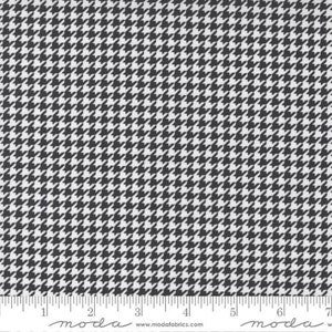 May include: Black and white houndstooth fabric with a repeating pattern. The fabric is shown with a ruler for scale.