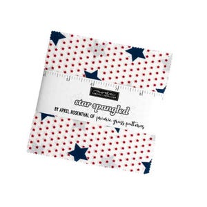 May include: A white fabric square with a red and blue star pattern. The fabric is labeled "star spangled" and "by April Rosenthal of prairie grass patterns".