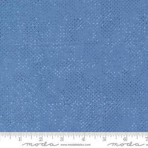 May include: A blue fabric with a subtle white speckled pattern. The fabric has a textured surface and a slightly faded look.