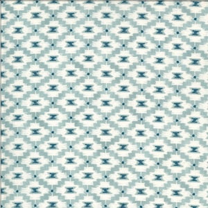 May include: A white fabric with a repeating pattern of blue and white geometric shapes. The pattern is a stylised diamond shape with a small circle in the centre.