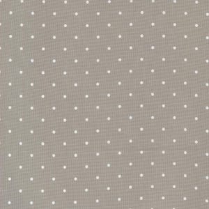 May include: A close-up of a light brown fabric with a white polka dot pattern.