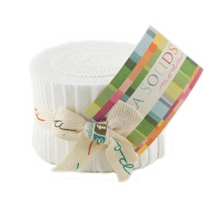 May include: A white Moda Bella Solids fabric roll tied with a natural twine bow. The label reads "Moda Bella Solids".