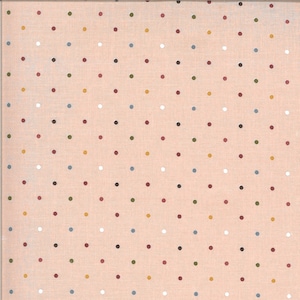 May include: A peach-colored fabric with a repeating pattern of small, evenly spaced polka dots. The dots are in various colors, including red, brown, yellow, green, blue, and white. The fabric has a slightly textured appearance.
