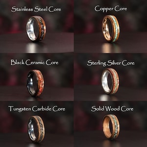 May include: Six different wood rings with various metal cores. The rings are made of wood with a thin metal band around the outside. The metal cores are stainless steel, copper, black ceramic, sterling silver, tungsten carbide, and solid wood.