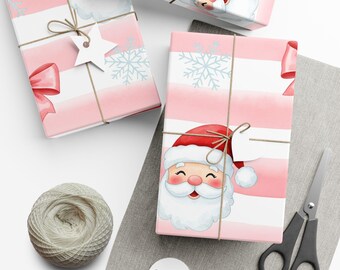May include: Several wrapped gifts with pink and white striped paper featuring Santa Claus illustrations and snowflakes. Each package is tied with twine and adorned with tags and bows. A spool of twine and scissors are also present.