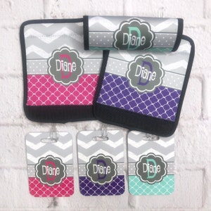 May include: Set of four personalized luggage tags with a chevron pattern and a monogrammed initial. The tags are in pink, purple, teal, and gray.
