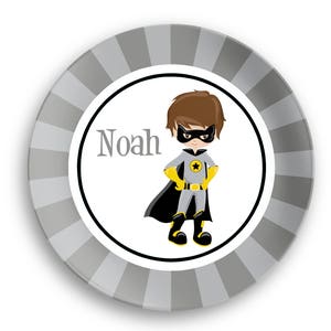 May include: A personalized gray and white plate with a black and yellow superhero illustration. The plate says "Noah" in black text.